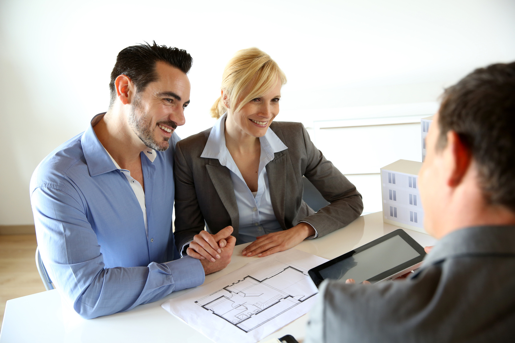 Couple meeting real-estate agent to buy property